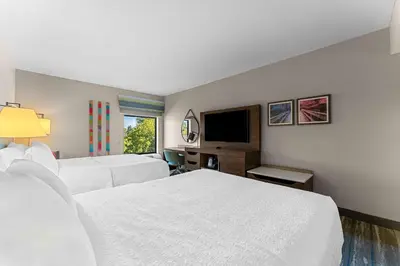 a hotel room with two beds and a flat screen tv at Hampton Inn Stroudsburg Poconos in Stroudsburg