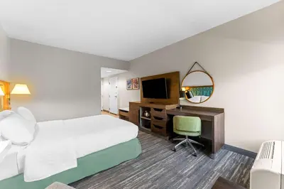 a hotel room with a bed and a desk with a computer at Hampton Inn Stroudsburg Poconos in Stroudsburg
