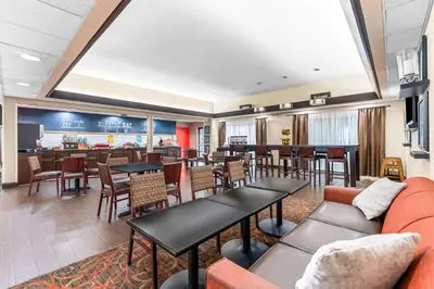 a lobby with tables and chairs and a bar at Hampton Inn Stroudsburg Poconos in Stroudsburg