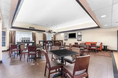 a dining room with tables and chairs and a large skylight at Hampton Inn Stroudsburg Poconos in Stroudsburg
