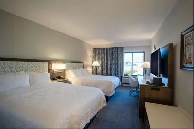 a hotel room with two beds and a television at Hampton Inn & Suites Fairfield in Fairfield