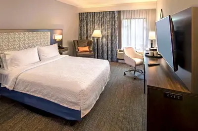 a hotel room with a bed and a flat screen tv at Hampton Inn & Suites Fairfield in Fairfield