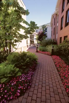 a brick walkway with flowers in front of a building at Hampton Inn & Suites Fairfield in Fairfield