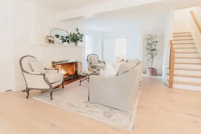 a living room with white furniture and a fireplace at Fairville Inn in Chadds Ford