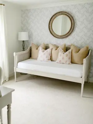 a white couch with pillows in a room with a mirror at Fairville Inn in Chadds Ford