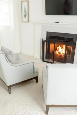a living room with a couch and a fireplace at Fairville Inn in Chadds Ford
