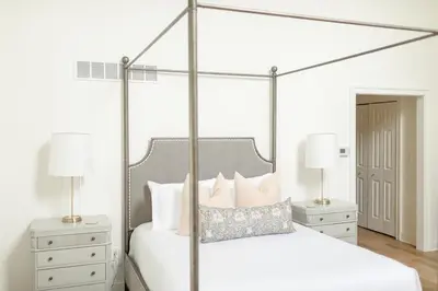 a bedroom with a canopy bed with two night stands at Fairville Inn in Chadds Ford