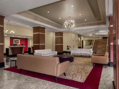 a lobby with couches and a chandelier at DoubleTree by Hilton Fort Lee/George Washington Bridge in Fort Lee