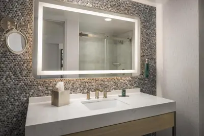 a bathroom with a sink and a mirror at DoubleTree by Hilton Fort Lee/George Washington Bridge in Fort Lee