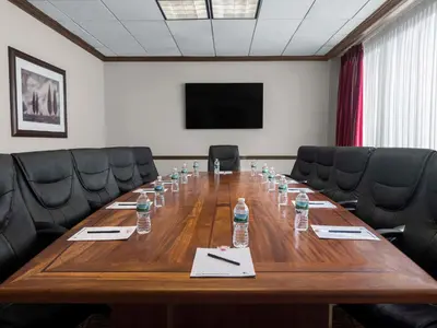 a conference room with a long wooden table and chairs at DoubleTree by Hilton Fort Lee/George Washington Bridge in Fort Lee