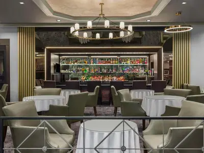 a restaurant with tables and chairs and a bar at DoubleTree by Hilton Fort Lee/George Washington Bridge in Fort Lee