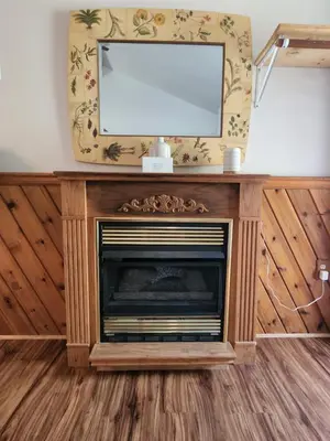 a fireplace with a television on top of it at Magnolia Streamside Resort in Canadensis