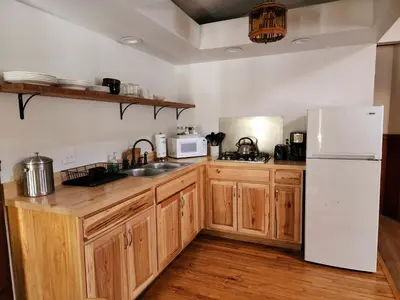 a kitchen with wooden cabinets and a white refrigerator at Magnolia Streamside Resort in Canadensis