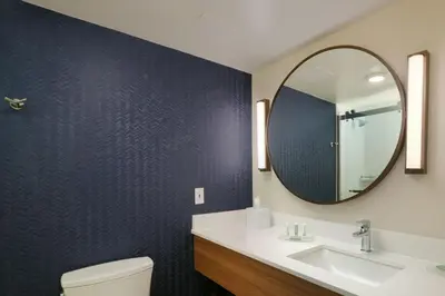 a bathroom with a sink and a mirror at Fairfield Inn & Suites by Marriott Pottstown Limerick in Pottstown