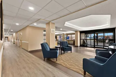 a waiting room with blue chairs and a table at Comfort Inn Bordentown near NJ Turnpike in Bordentown