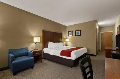 a hotel room with a bed and a chair at Comfort Inn Bordentown near NJ Turnpike in Bordentown