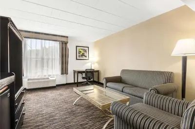 a living room with couches and a coffee table at Best Western Hazlet Inn in Hazlet