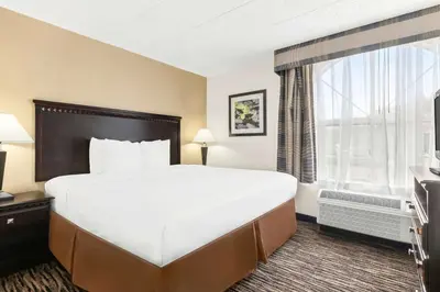 a hotel room with a large bed and a window at Best Western Hazlet Inn in Hazlet