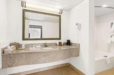 a bathroom with a sink and a mirror at Best Western Hazlet Inn in Hazlet