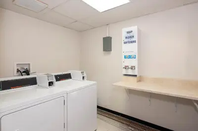 a white room with two microwaves on a counter at Red Roof Inn & Suites Mt Holly - McGuire AFB in Westampton Township
