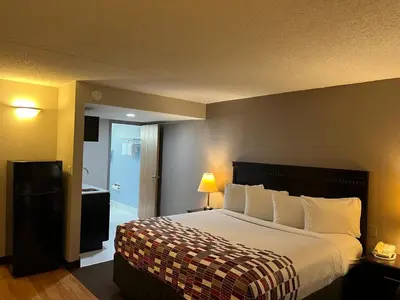 a hotel room with a bed and a bathroom at Red Roof Inn & Suites Mt Holly - McGuire AFB in Westampton Township