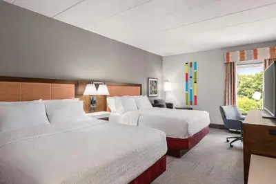 a hotel room with two beds and a television at Hampton Inn Quakertown in Quakertown