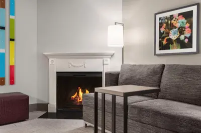 a living room with a couch and a fireplace at Hampton Inn Quakertown in Quakertown