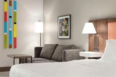 a hotel room with a couch and a bed at Hampton Inn Quakertown in Quakertown