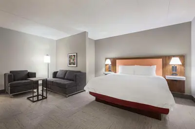 a hotel room with a bed and a chair at Hampton Inn Quakertown in Quakertown
