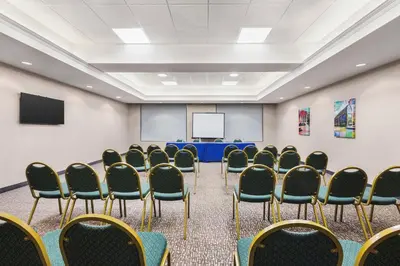 a conference room with chairs and a table and a screen at Hampton Inn Quakertown in Quakertown