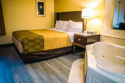 a hotel room with a bed and a bath tub at Inn at York in York