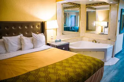 a bedroom with a bed and a tub and a sink at Inn at York in York