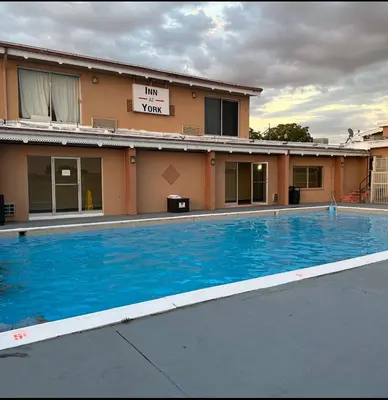 a large blue swimming pool in front of a building at Inn at York in York