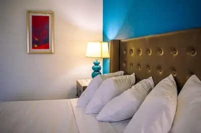 a bedroom with a bed with white pillows and a lamp at Inn at York in York