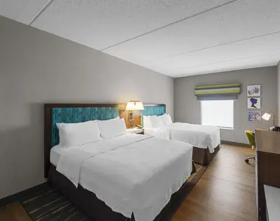 a hotel room with two beds and a window at Hampton Inn Nanuet in Nanuet