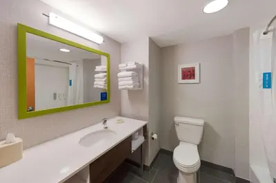 a bathroom with a toilet and a sink and a mirror at Hampton Inn Nanuet in Nanuet