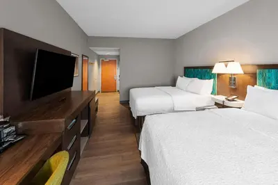 a hotel room with two beds and a flat screen tv at Hampton Inn Nanuet in Nanuet