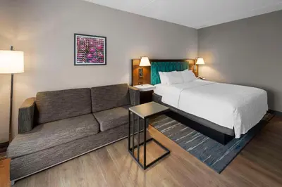 a hotel room with a bed and a couch at Hampton Inn Nanuet in Nanuet