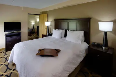 a hotel room with a large bed with a tray on it at Hampton Inn Harrisburg/Grantville/Hershey in Grantville