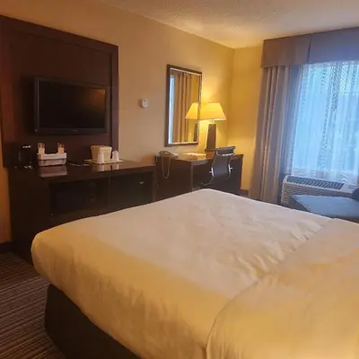 a hotel room with a bed and a television at Best Western Chocolate Inn at the Park in Hummelstown