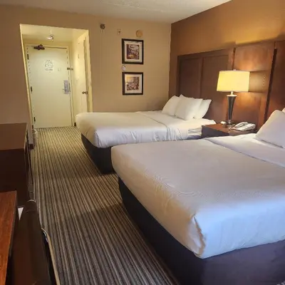 a hotel room with two beds and a lamp at Best Western Chocolate Inn at the Park in Hummelstown