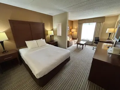 a hotel room with a large bed and a desk at Best Western Chocolate Inn at the Park in Hummelstown