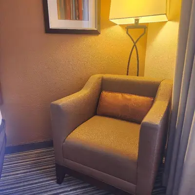 a chair with a pillow in a hotel room at Best Western Chocolate Inn at the Park in Hummelstown