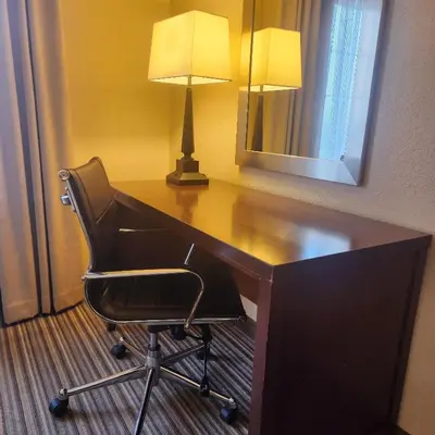 a desk with a chair and a lamp in a hotel room at Best Western Chocolate Inn at the Park in Hummelstown