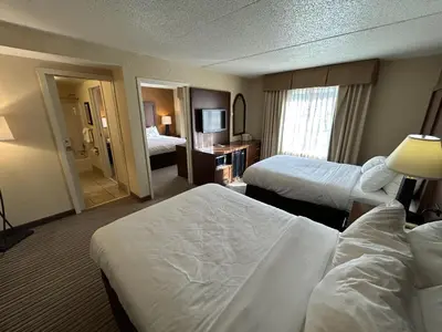a hotel room with two beds and a television at Best Western Chocolate Inn at the Park in Hummelstown