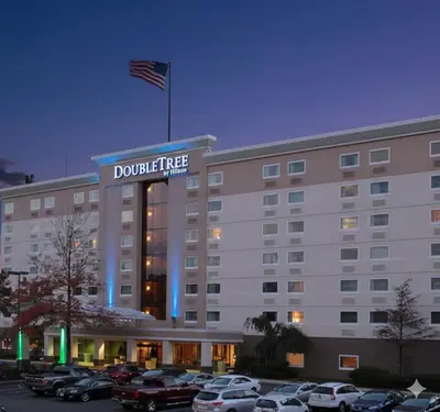 a building with an american flag on top of it at DoubleTree by Hilton Wilkes-Barre in Wilkes-Barre