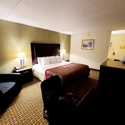 a hotel room with a bed and a couch at Town Inn in Bordentown
