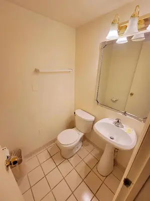 a bathroom with a toilet and a sink at Town Inn in Bordentown