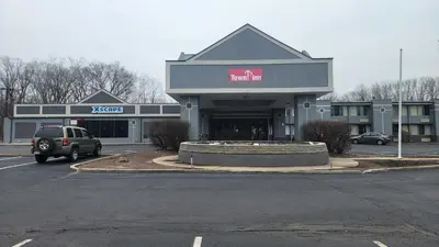 a car parked in front of a building with a mall at Town Inn in Bordentown