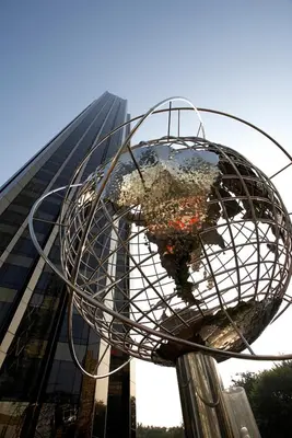 a metal globe on a pole in front of a building at Trump International New York in New York